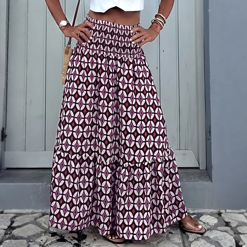 In the summer of 2026, a national style pleated A-line skirt with leafy hem, a beach-inspired long dress for ladies
